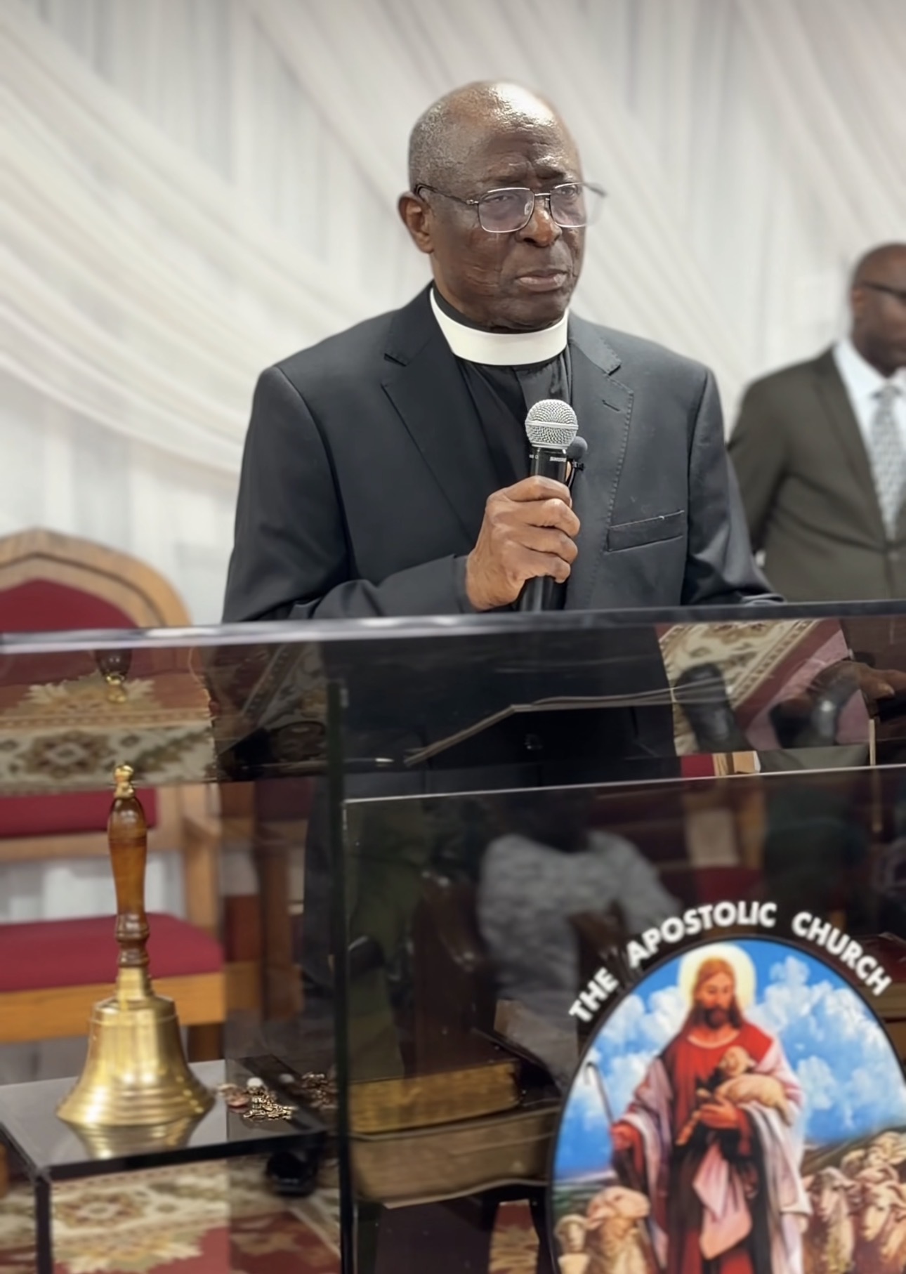 Pastor (Dr.) Bisi Asere preaching at the pulpit